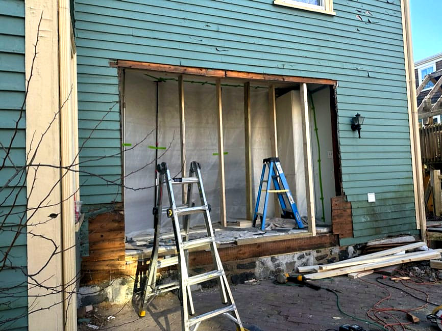 Exterior wall opening framed for new addition with rough opening prepped, Connecticut carpentry project