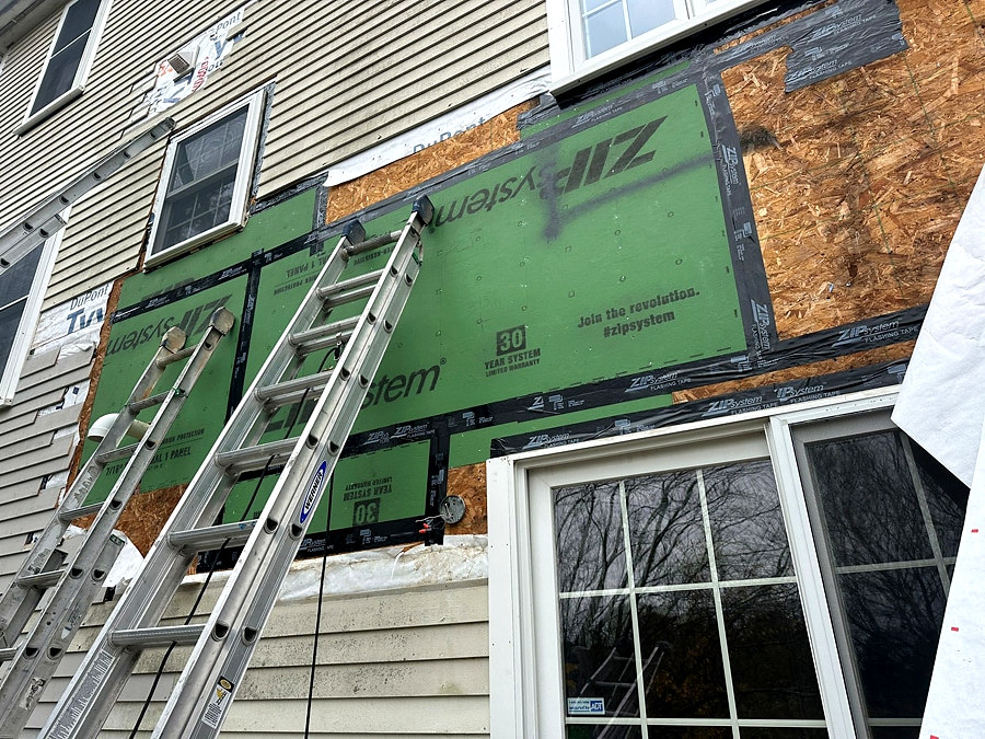 ZIP System sheathing installed on exterior wall over removed siding, Connecticut carpentry project