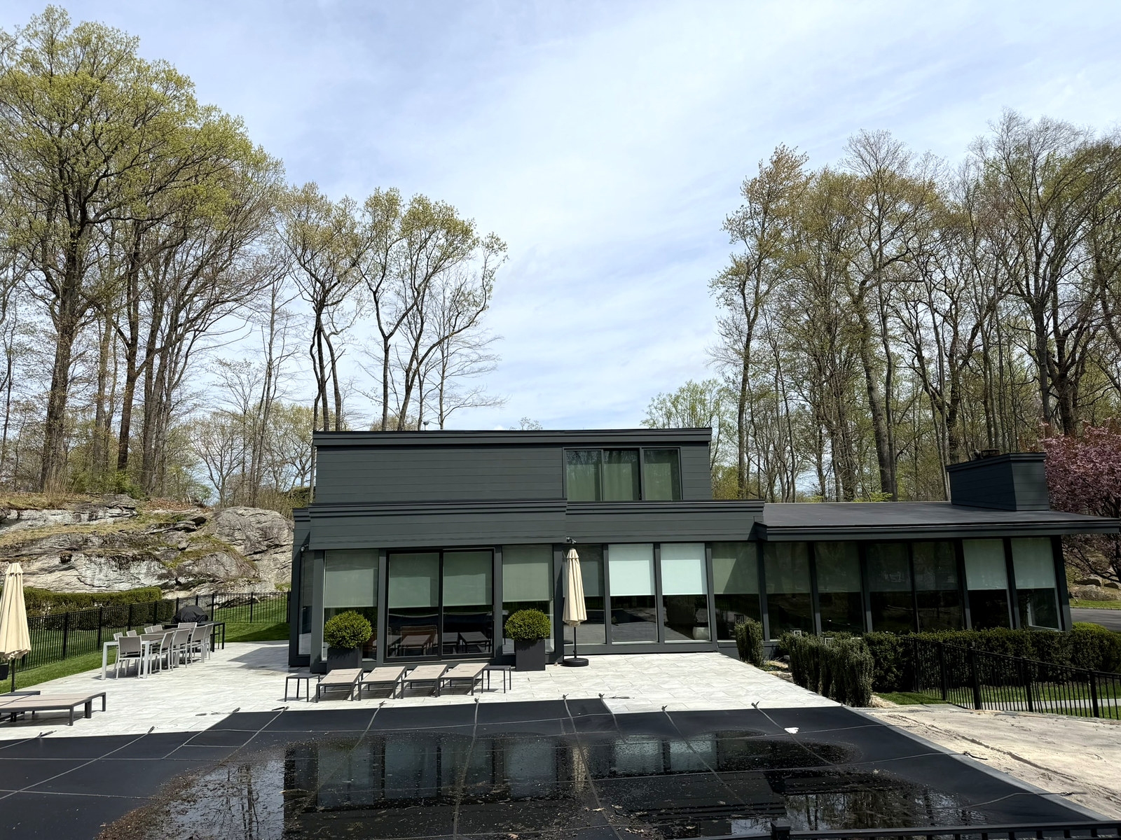 Modern pool house with dark charcoal exterior