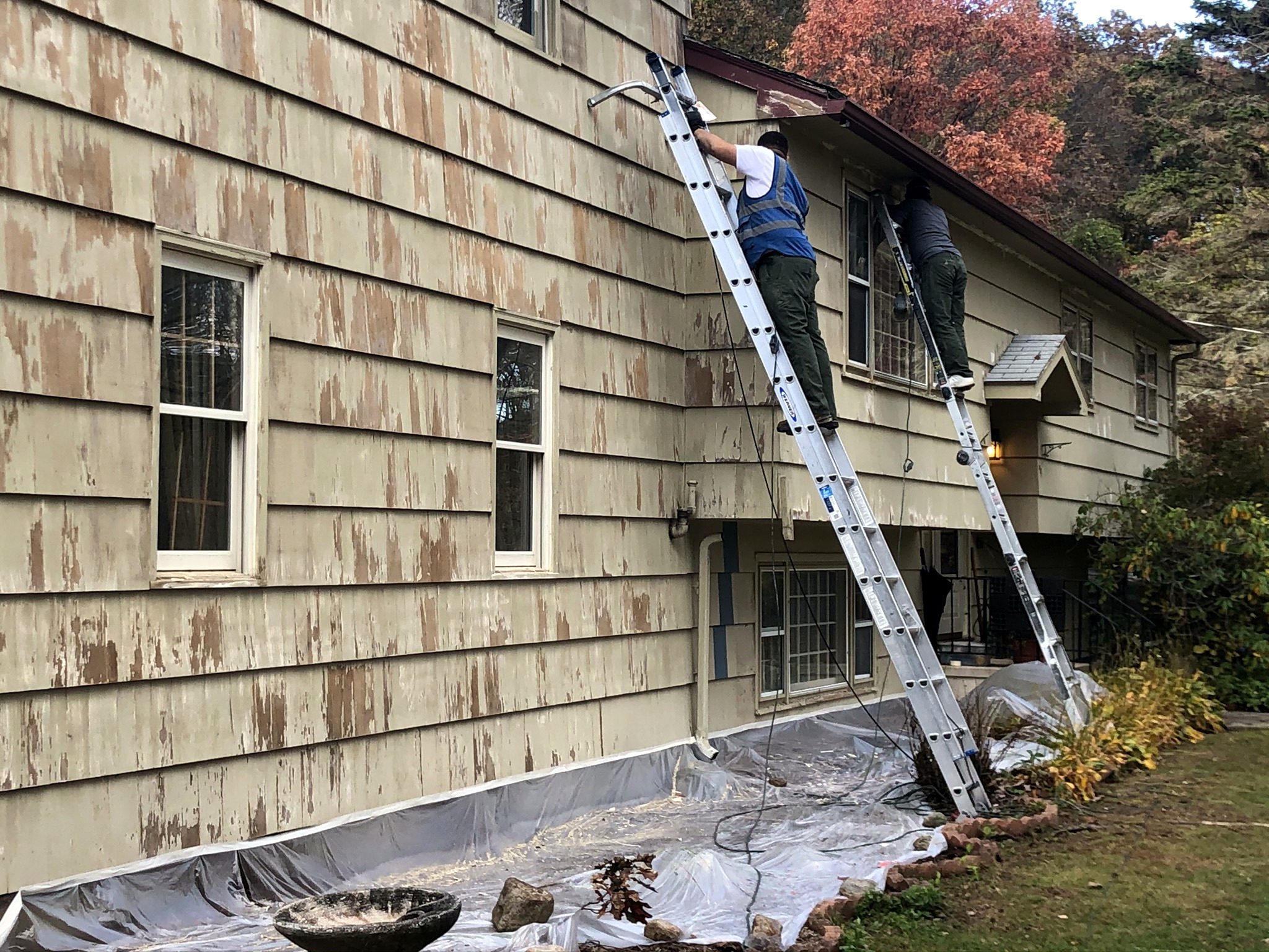 Cedar shingle siding restoration with replaced sections on Connecticut home