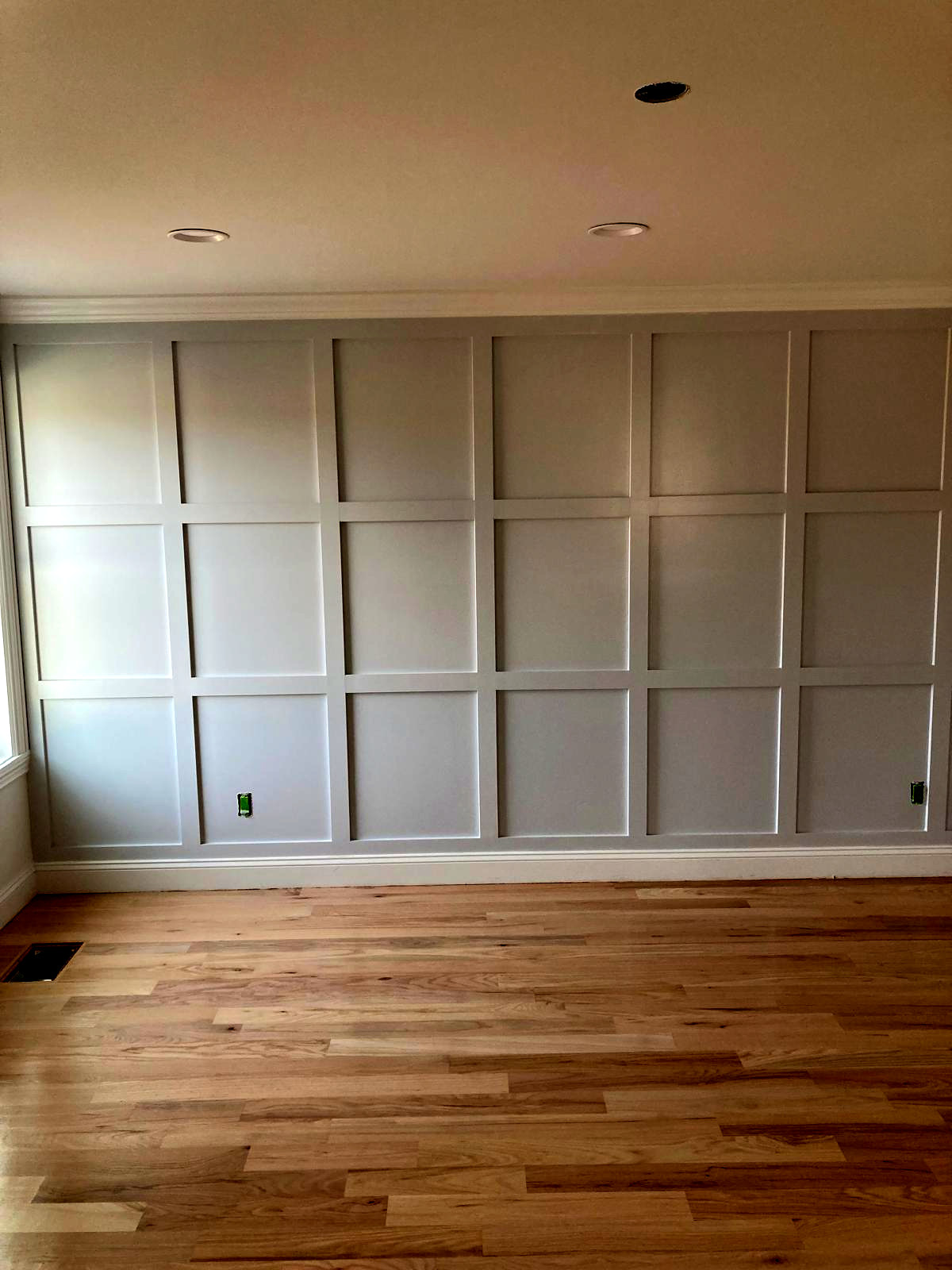 Custom board-and-batten accent wall painted soft gray with white trim, Connecticut interior project