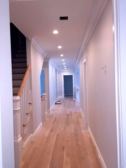 Long second-floor hallway with fresh light gray walls and crisp white trim, Connecticut interior project