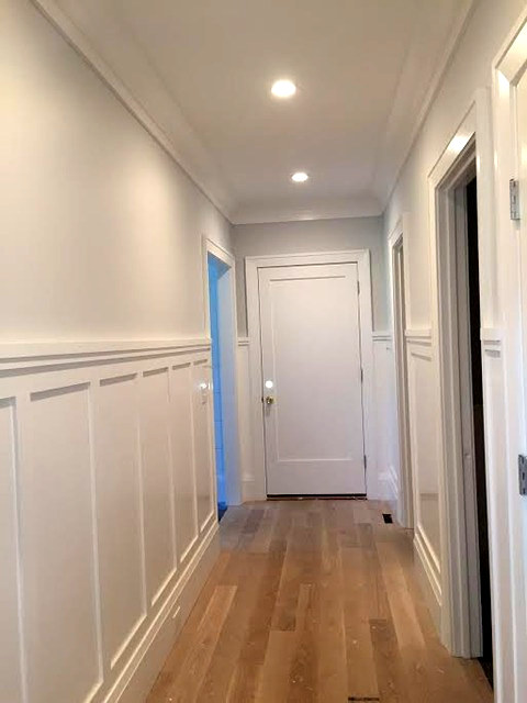 Hallway with custom board-and-batten wainscoting and bright white doors and trim, Connecticut interior project
